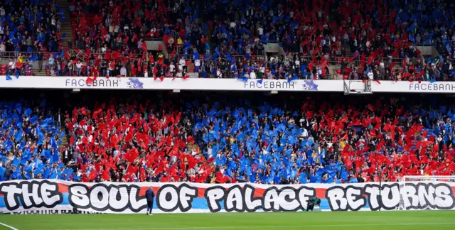 A fan banner reading 'The Soul of Palace returns' at Selhurst Park