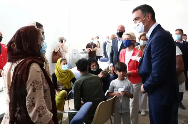 Spain's Prime Minister Pedro Sanchez (R) and senior EU officials speak to Afghan evacuees