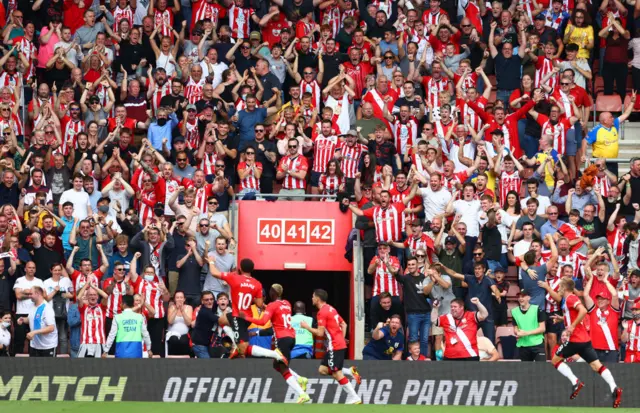 Che Adams celebrates the opening goal in front of the Southampton fans