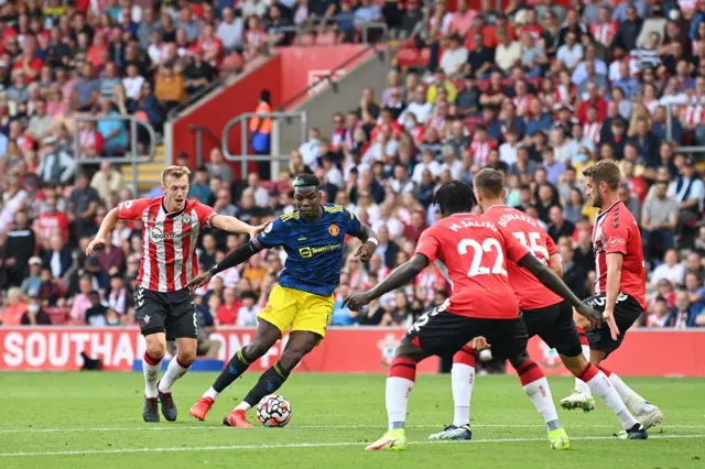 Paul Pogba controls the ball with Southampton defenders around him