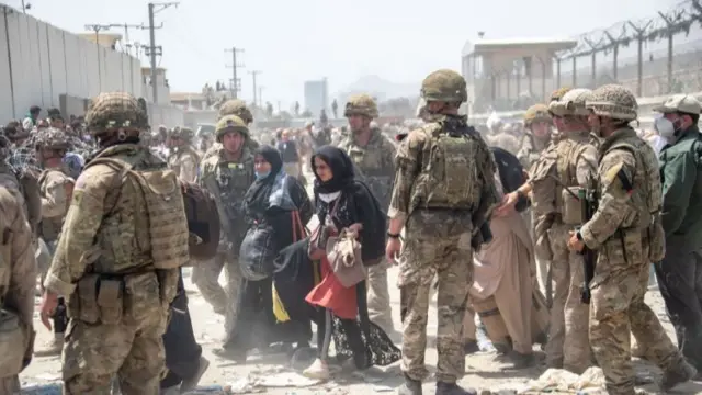 members of the British and US military engaged in the evacuation of people out of Kabul