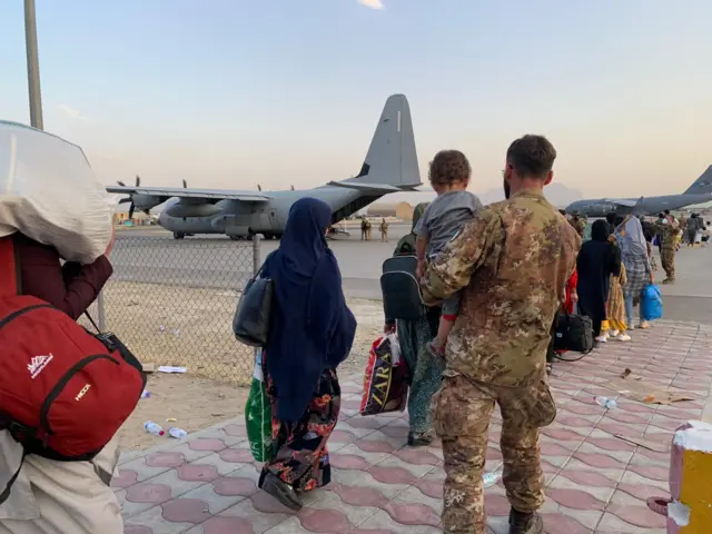 Afghans prepare to board flights at Kabul international airport