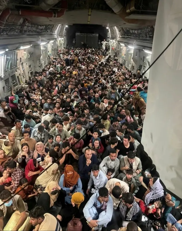 Evacuees crowd the interior of a U.S. Air Force C-17 Globemaster III transport aircraft, carrying some 640 Afghans to Qatar from Kabul, Afghanistan August 15, 2021