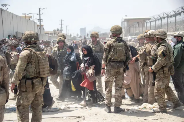 British and US military helping evacuate people at Kabul airport