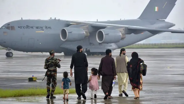 People walking towards Indian plane