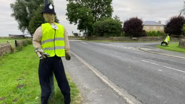 Scarecrow dressed as a police officer