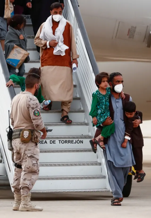 Afghan citizens evacuated from Kabul arrive at Torrejon Air Base, outside Madrid, Spain. Photo: 24 August 2021