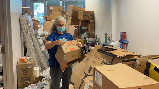 Delivery boxes sent by donors fill a refugee aid agency in Texas