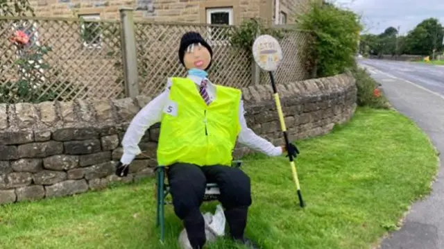 Scarecrow dressed as a lollipop man