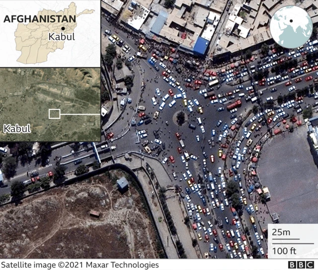 A satellite photo of Kabul airport showing crowds outside the walls.