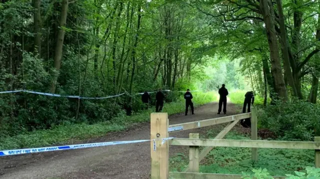 Police cordon and officers searching