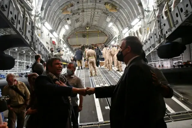 Afghan media workers and their families are greeted by Mexican Foreign Minister Marcelo Ebrard (right) at Mexico City's airport. Photo: 25 August 2021