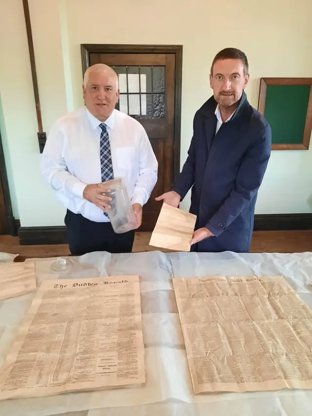 Leader of Dudley Council, Councillor Patrick Harley, and Black Country Living Museum director Andrew Lovett survey the contents of the capsule