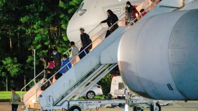 British nationals and Afghan evacuees depart a flight from Afghanistan at RAF Brize Norton on 17 August 2021