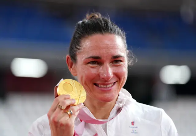 Sarah Storey holds up her gold medal