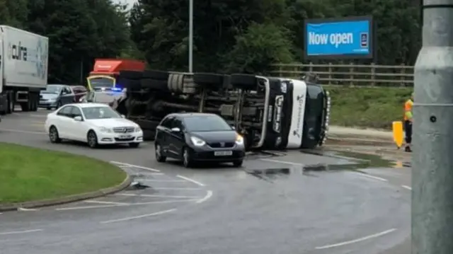 Overturned truck on roundabout on A426 in Lutterworth, Leicestershire