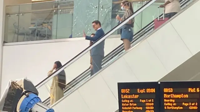 Tom Cruise on an escalator