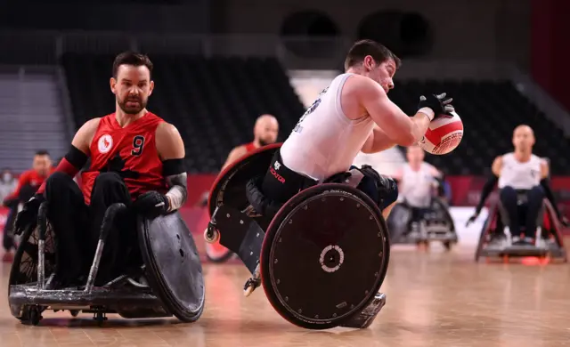 Jamie Stead of Team Great Britain falls to the floor after being tackled by Cody Caldwell of Team Canada during the Wheelchair Rugby Pool Phase Group match