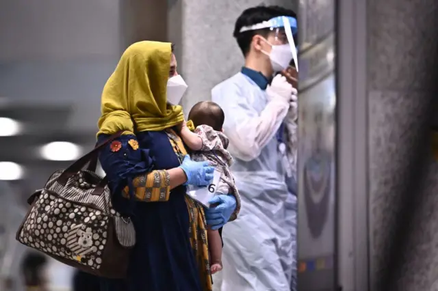 Afghan evacuees arrive at Incheon International Airport in Incheon on August 26, 2021,