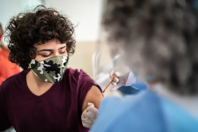 teenager being vaccinated