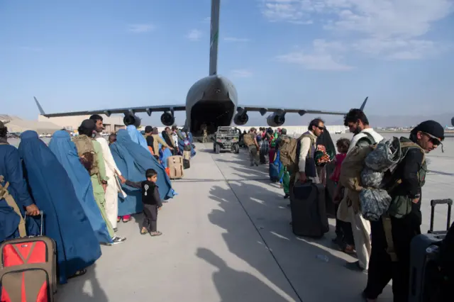 people waiting to get on a repatriation flight at Kabul airport