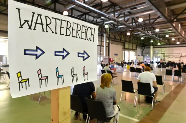 People rest after receiving a vaccine at a centre in Dresden, Germany, on 29 July 2021