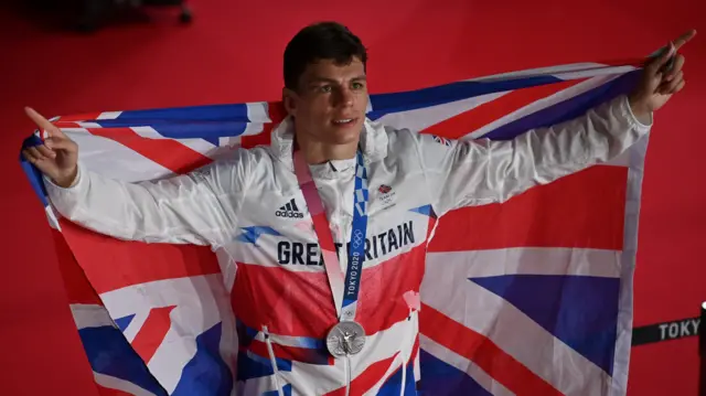 Pat McCormack with union flag and silver Olympic medal