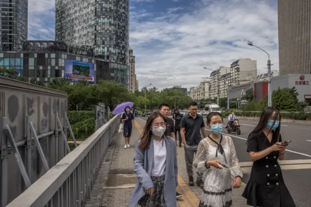 People wearing masks walking in Beijing