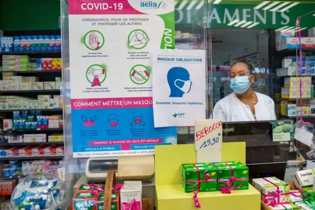 Placards indicating health measures against the Covid-19 at a pharmacy in Pointe-a-Pitre, on the French Caribbean archipelago of Guadeloupe