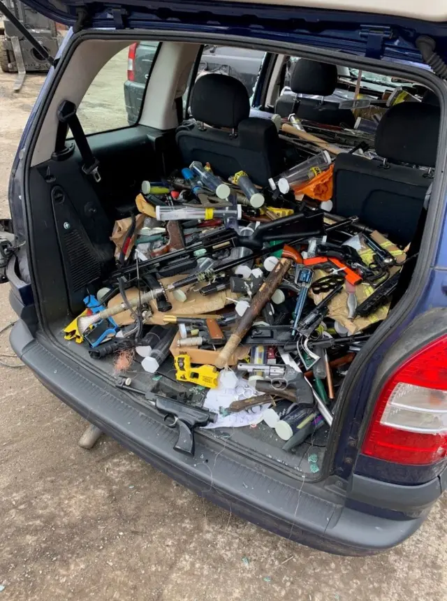 Car boot loaded with weapons and firearms