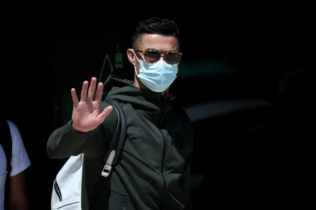 Cristiano Ronaldo waves at fans