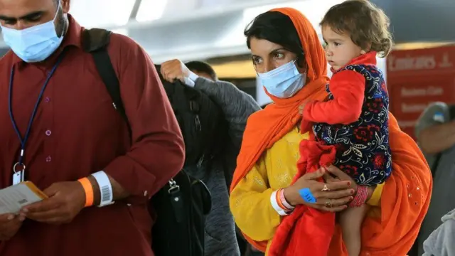 An Afghan woman arrives at Dulles airport after fleeing the Taliban