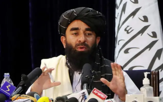 Zabihullah Mujahid seen at a media conference