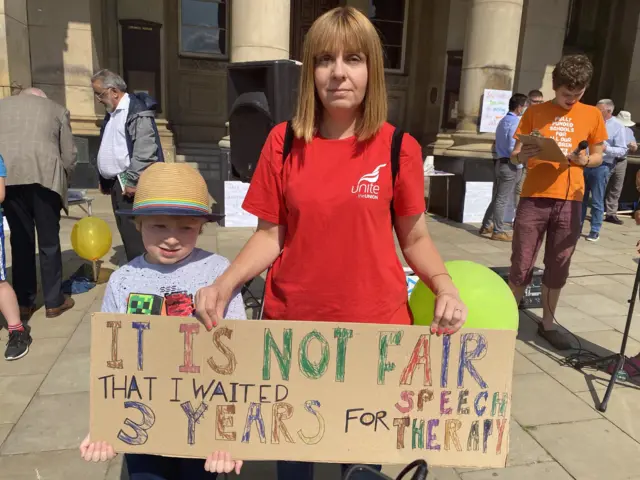 Joanne Shemmans, with grandson Jacob, at the demo in Victoria Square