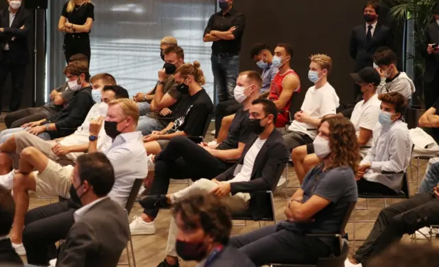 Barca players and manager watching the Lionel Messi news conference