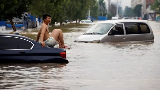 A man trapped on a car in flooding in Zhengzhou