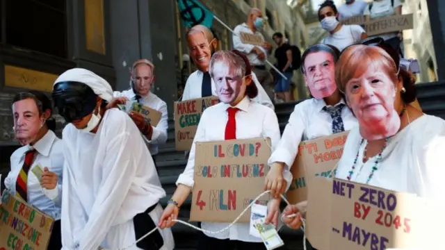 Climate protesters in Naples wearing masks of world leaders in July 2021