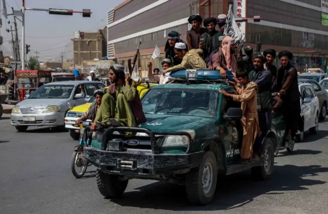 Taliban fighters rally to celebrate the withdrawal of US forces in Kandahar, Afghanistan. Photo: 31 August 2021