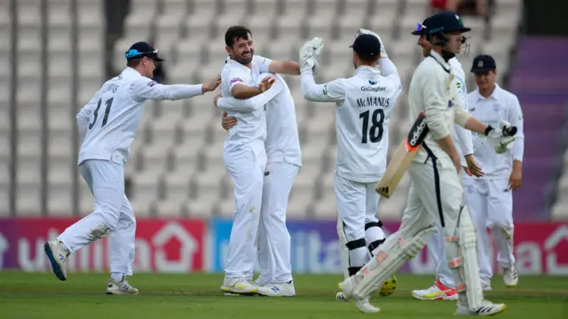 Ian Holland takes a wicket