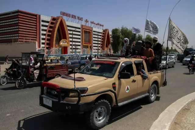 Taliban fighters in Kandahar celebrate the departure of US troops