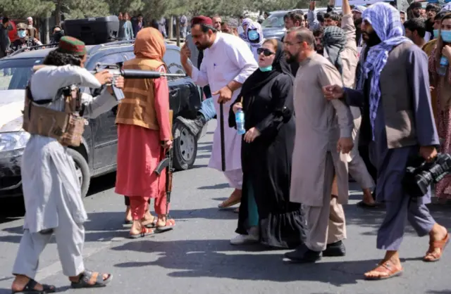 A member of the Taliban forces points his gun at protesters in Kabul. Photo: 7 September 2021