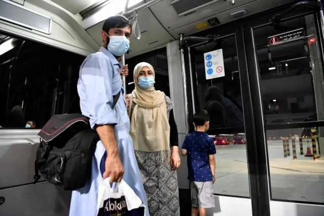 Passengers look on in an airport bus after disembarking a Qatar Airways plane that landed from Kabul, Afghanistan in Doha, Qatar, on 9 September 2021