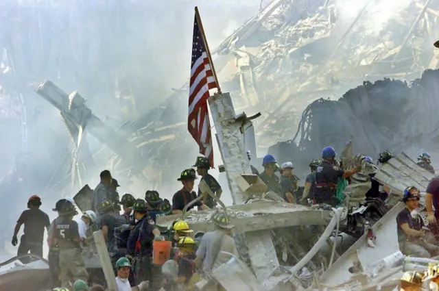 A US flag is seen posted in the rubble of the World Trade Center in New York