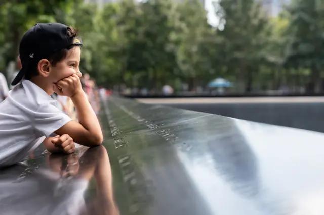 A boy mourns at the 9/11 memorial