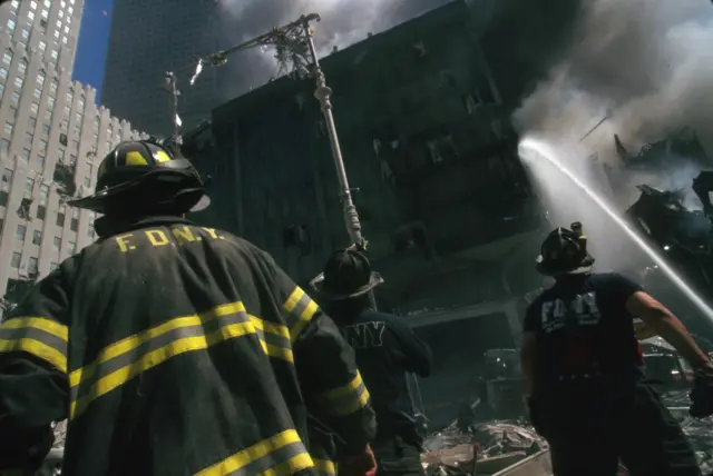 Colour photograph of a New York Fire-fighter amid the rubble of the World Trade Centre following the 9/11 attacks. Dated 2001.