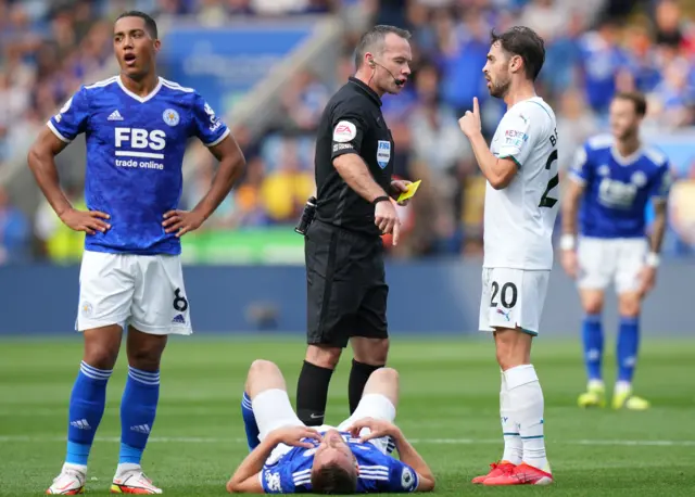 Bernardo Silva interacts with the ref while Jamie Vardy is down