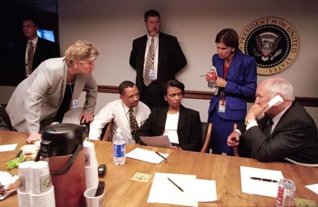 In this photo released by The White House 16 September, 2001, US Vice President Dick Cheney (R) speaks by phone to US President George W. Bush from the operations center at the White House in Washington, DC, 11 September, 2001