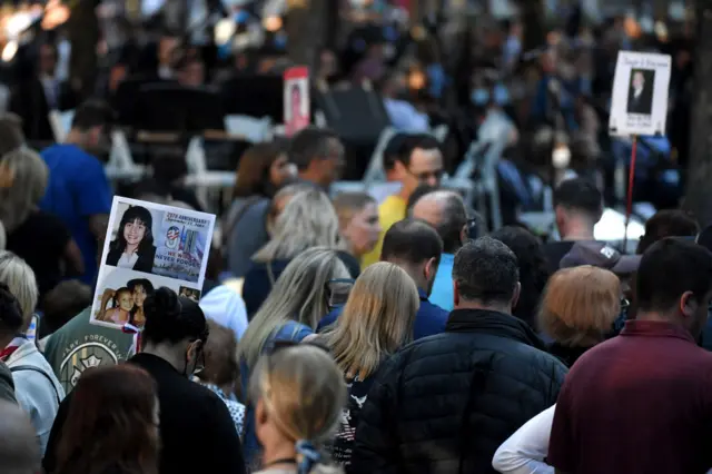 The photo of a 9/11 victim is carried by family and friends as they attend a ceremony commemorating the 20th anniversary of the 9/11 attacks on the World Trade Center