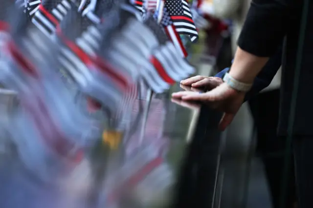 People place their hands on the memorial during the annual 9/11 Commemoration Ceremony at the National 9/11 Memorial and Museum on September 11, 2021 in New York City