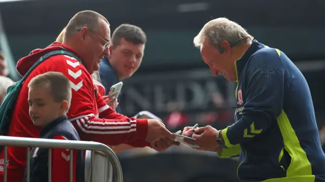 Neil Warnock signs an autograph